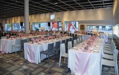 the tables are set up with pink and white tablecloths for an elegant event