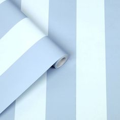 a blue and white striped wallpaper with a roll of tape on top of it