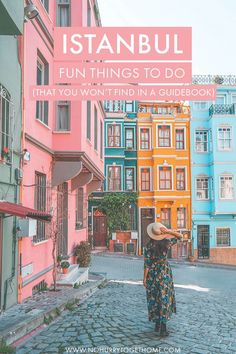 a woman standing in the middle of a cobblestone street with colorful buildings and text overlay that reads, istanbul fun things to do that you won't find in a guidebook