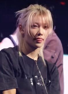 a person with blonde hair and piercings on