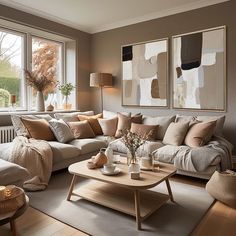 a living room filled with lots of furniture next to a large window covered in paintings