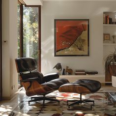 an eames chair and ottoman in the living room