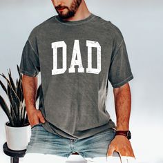 "FREE SHIPPING IN THE US! No order minimum! Comfort Colors, Dad Shirt, New Dad Shirt, Gift for New Dad, Father's Day Shirt , Dad Shirt, Dad's Tshirt, Father's Day Gift, Dad Shirt Gift ♥ The SHIRT * This is a Comfort Colors 1717 shirt. * This unisex fit t-shirt is intended to be loose/oversized for women to give a chic and laid back vibe. If you want the tee to be more fitted, we would recommend sizing down. * If you are looking for an oversized \"T-shirt Dress\" look, we recommend sizing up 1 or 2 sizes * Detailed sizing information can be found in the size chart in the photos. * Printed in the USA ♥ CARE ＊Machine wash cold, inside-out, gentle cycle ＊Wash with mild detergent and similar colors ＊Tumble dry low or hang-dry ＊Do not bleach or fabric softeners ＊Do not iron directly onto the des Gift For New Dad, Papa Shirts, Oversized T Shirt Dress, Gifts For New Dads, Fathers Day Shirts, Adulting Shirts, New Dads, Oversized T Shirt, Dad To Be Shirts