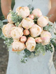 a bride holding a bouquet of flowers in her hands