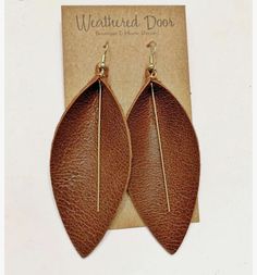 the leather leaf earrings are brown and have gold colored metal earwires on them