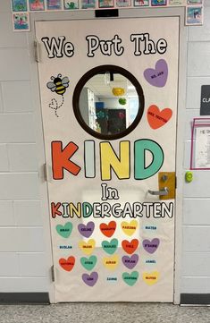 a classroom door decorated with hearts and the words, we put the kind in kindergarten