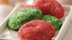 three red and green donuts on a white plate