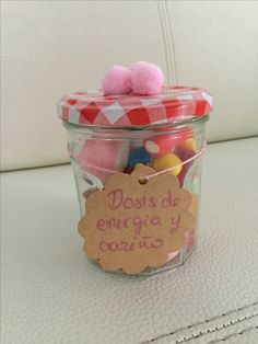 a jar filled with lots of different colored candies