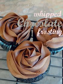 three cupcakes with chocolate frosting sitting on a cooling rack