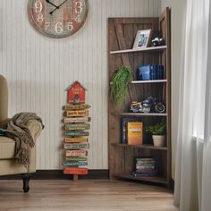 a living room filled with furniture and a large clock on the wall above it's bookshelf