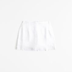 Ultra high rise mini skort in our soft linen-blend fabric, featuring a shorts lining for comfort and side zipper for a secure fit. White Mini Skort, White Mini Skirt With Short Inseam For Summer, White Summer Skort With Short Inseam, White Skort With Short Inseam For Summer, Fitted Linen Mini Skirt For Summer, Casual Mini Skirt With Short Inseam For Summer, Chic Linen Mini Bottoms, Fitted Linen Summer Shorts, Linen Mini Skirt For Summer