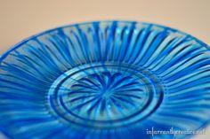 a blue glass plate sitting on top of a table