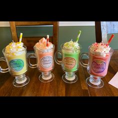 three different types of drinks sitting on top of a wooden table next to each other