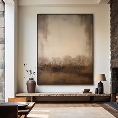 a living room with a large painting hanging on the wall next to a couch and coffee table