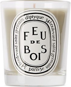 a candle that is sitting in front of a white background with the words feu de bos on it