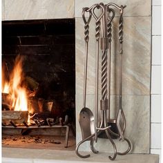 a fireplace with fire in it and some kind of utensils