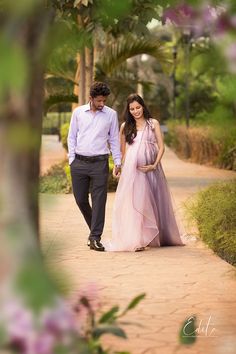 a man and woman walking down a path