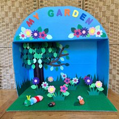 an open cardboard garden with flowers and plants