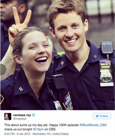 two police officers are smiling and giving the peace sign