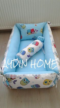 an inflatable baby bed with owls and owls on it is sitting on the floor