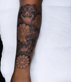 a woman's arm with flowers and an elephant tattoo on the left side of her leg