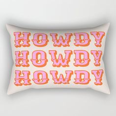 an orange and pink pillow with the words howdy hodwy in bold font