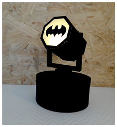 a batman lamp on top of a black stand