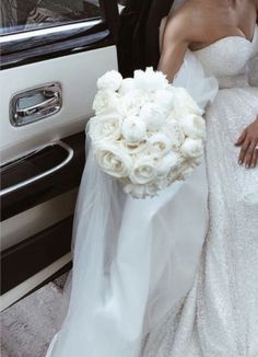 the bride and groom are getting out of their limo together, dressed in white flowers