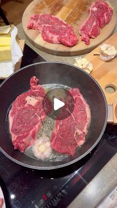 raw meat being cooked in a frying pan on top of an electric burner