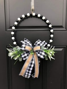 a black and white wreath on a door