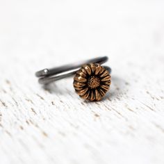 Adjustable floral sunflower ring to wear as knuckle ring, toe ring or as a regular ring on any finger. The tiny flower is made in bronze and the adjustable ring band in stainless steel. Both bronze and steel are strong hard metals and this makes a very durable design. MADE ON DEMAND, takes me up to 7 workdays to complete. Here you find other designs with flowers https://www.etsy.com/se-en/shop/AnnaSiivonen?ref=seller-platform-mcnav&search_query=flower Adjustable Copper Flower Jewelry, Adjustable Flower Shaped Metal Ring, Adjustable Metal Flower Ring, Dainty Adjustable Hand Forged Stackable Rings, Dainty Hand Forged Adjustable Stackable Rings, Dainty Adjustable Stackable Flower Ring, Adjustable Nickel-free Copper Ring, Adjustable Copper Nickel-free Rings, Adjustable Brass Flower Ring As Gift