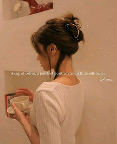 a woman holding a coffee cup in her right hand and looking into the mirror with an inspirational quote on it