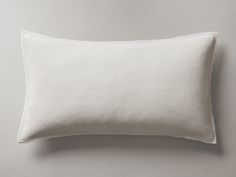 a white pillow on a gray wall