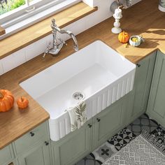 a large white sink sitting on top of a counter next to a wooden countertop