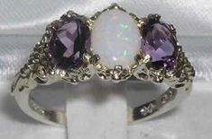 "A stunning made to order 18K White Gold ornate Trilogy Ring handset with a natural Australian Opal and two vibrant dark natural Amethysts The centre opal measures 8 x 6mm (0.32\" x 0.24\") and the two 7 x 5mm (0.28\" x 0.20\") vibrant natural Amethysts The gemstones are natural, earth-mined and ethically sourced and weigh: Opal 0.75ct Amethyst 1.5ct All of our jewellery is fully tested and hallmarked by the London, Birmingham or Dublin Assay Office, giving you the assurance of a high quality pi Trilogy Ring, Precious Opal, Carved Ring, Natural Opal, Anniversary Ring, Amethyst Ring, Pink Tourmaline, Victorian Fashion, Anniversary Rings