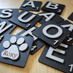 black and white coasters with dog's paw on them, which spell out the word roxv