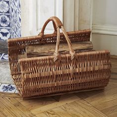 a brown wicker basket sitting on top of a wooden floor