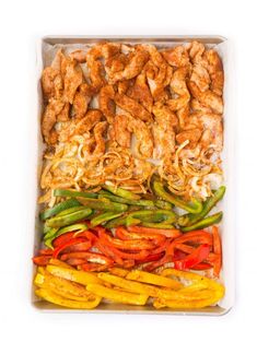 chicken and peppers in a tray on a white background