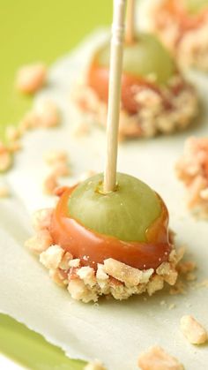 an apple is sitting on top of crackers with toppings and a toothpick