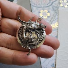 Gargoyle Dragon Guardian Protection Locket ☻Locket ~ Round Silver ~ With Bronze Bunny ~ With Flower ~ See Photos for size comparison against American quarter Chain: ~ Silver Plated YOU CHOOSE YOUR CHAIN LENGTH during checkout ☻More Lockets Here: https://www.etsy.com/shop/FashionCrashJewelry/search?search_query=lockets&order=date_desc&view_type=gallery&ref=shop_search ☻Link to The ENTIRE SHOP: https://www.etsy.com/shop/FashionCrashJewelry?ref=shopsection_shophome_leftnav&ga_search Dragon Locket, Magical Beasts, Dragons Breath, Faith Jewelry, Chain Silver, Size Comparison, Fantasy Jewelry, Pendant Silver, Saint Paul