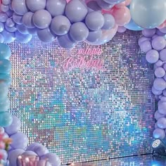 balloons and streamers fill the backdrop for a birthday party