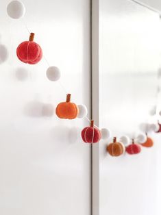 an orange, white and red decoration hangs on the wall