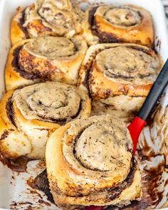 cinnamon rolls in a baking dish with chocolate sauce