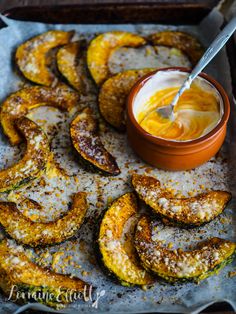 baked zucchini chips with dipping sauce on top