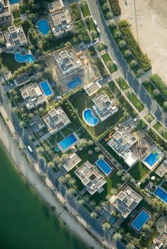 an aerial view of some houses with swimming pools