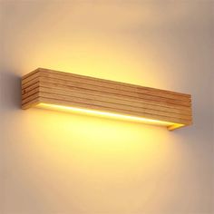 a light that is on the side of a wall with wooden planks in it