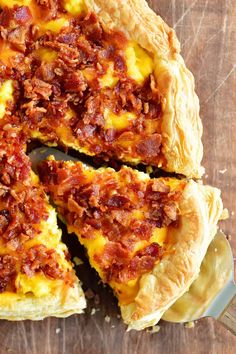 a pizza pie is cut into slices on a cutting board