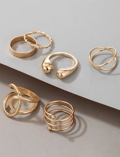 Introducing our exquisite 6pc Gold Hollow Out Ring Set, the epitome of elegance and versatility. Crafted with precision and adorned with intricate hollow-out detailing, each ring in this set exudes sophistication and charm. Perfect for the modern woman who values both style and simplicity, these rings effortlessly elevate any everyday ensemble. Whether paired with a casual jeans-and-tee look or a chic office outfit, these rings add a touch of glamour to every moment. Made from high-quality mater Elegant Alloy Rings For Gift, Gold Alloy Midi Rings, Elegant Alloy Ring Jewelry, Elegant Metal Stackable Rings, Elegant Adjustable Alloy Rings, Metal Midi Rings For Wedding, Classic Metal Midi Rings, Elegant Alloy Midi Rings As Gift, Elegant Alloy Midi Rings For Gifts