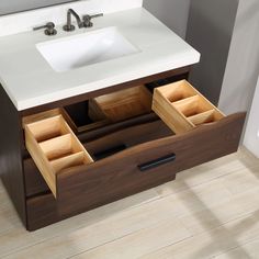 a bathroom vanity with two drawers and a sink in the middle, on top of a wooden floor