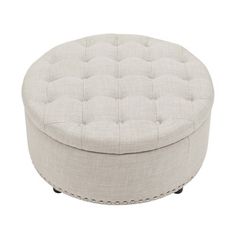 a white round ottoman with buttons on the front and back legs, sitting on a white background